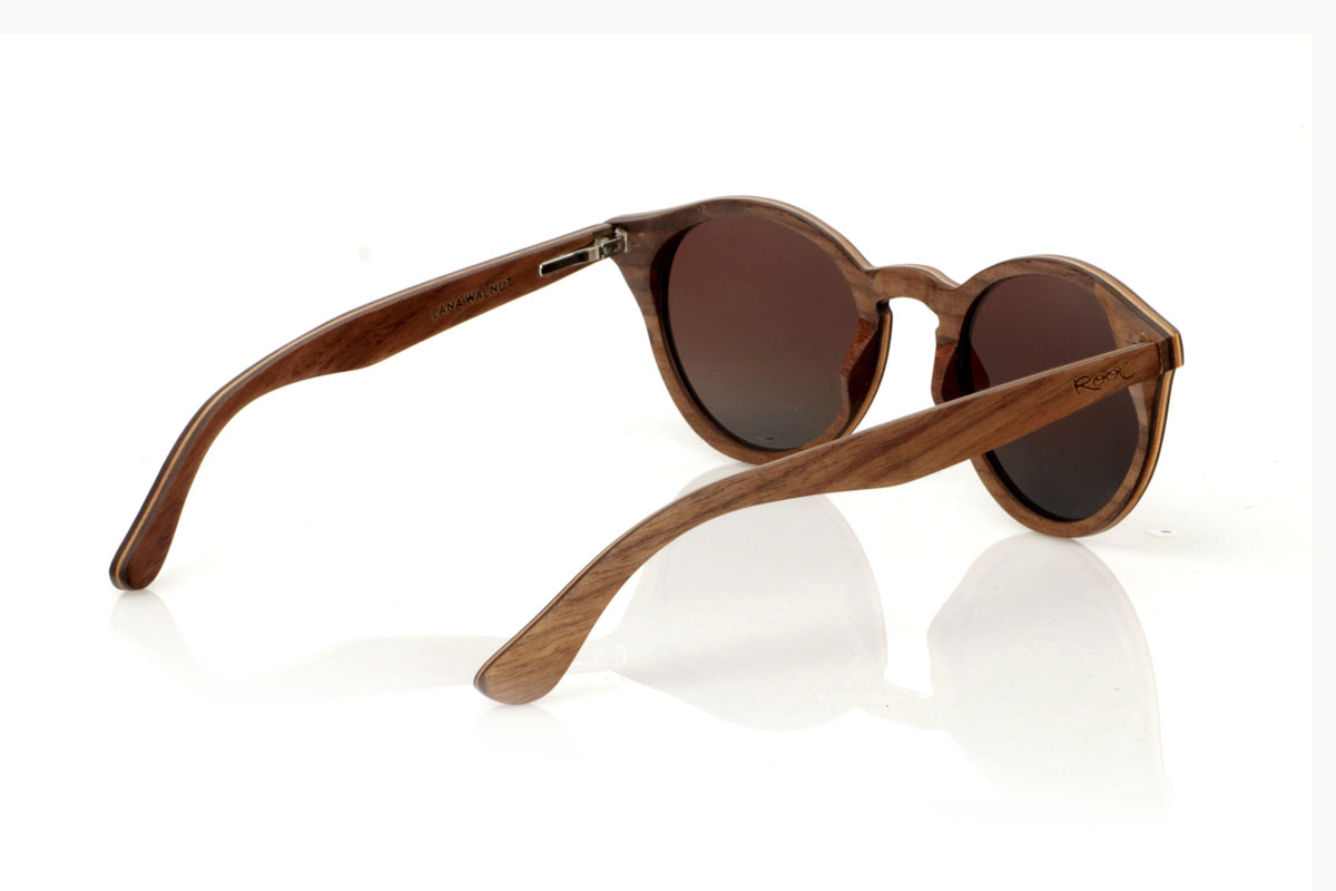 Wood eyewear of Walnut LANA. LANA wooden sunglasses, from our collection of organic glasses, entirely made of laminated walnut wood. This model perfectly combines natural elegance with an iconic design: a rounded shape with a straight eyebrow, creating a visual balance that enhances any type of face. But what really sets LANA apart are the sparkling Czech crystals embedded at the ends of the brows, adding a touch of light and sophistication. Ideal for those looking to stand out with a unique accessory, LANA is not just a pair of glasses, but a statement of style and ecological awareness. Measurements 147x50mm Caliber 47 for Wholesale & Retail | Root Sunglasses® 